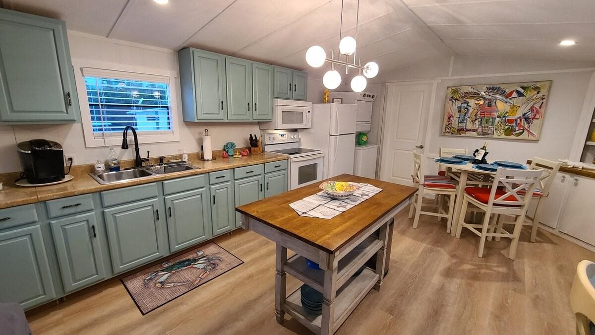 Kitchen and Breakfast Area with Microwave, Stove, Full Sized Refrigerator w/ Freezer, Keurig Coffee Maker and all plates, cups, utensils, pots and pans.

Washer and Dryer also in unit. 